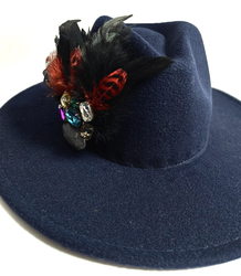 Elegant women's hat with large brooch with feathers and colored zircons