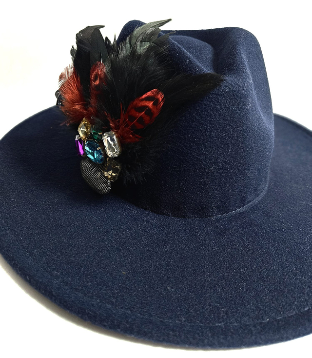 Elegant women's hat with large brooch with feathers and colored zircons