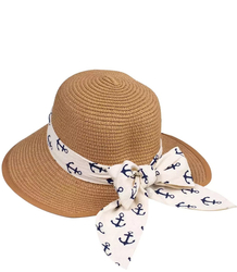 Stylish straw hat with a bow in anchors