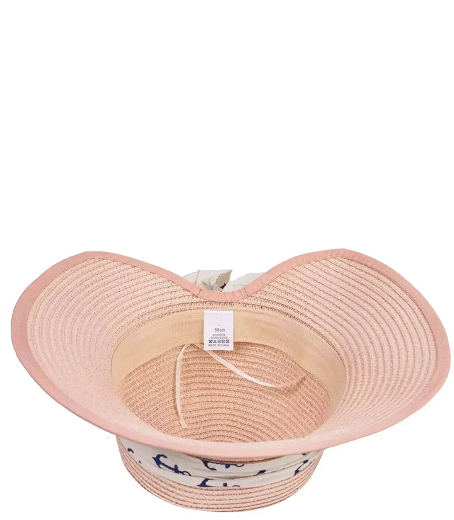 Stylish straw hat with a bow in anchors