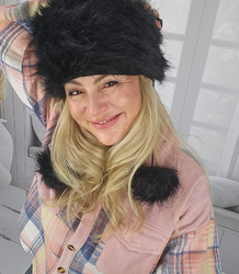 Fluffy winter beanie with pom-poms on strings