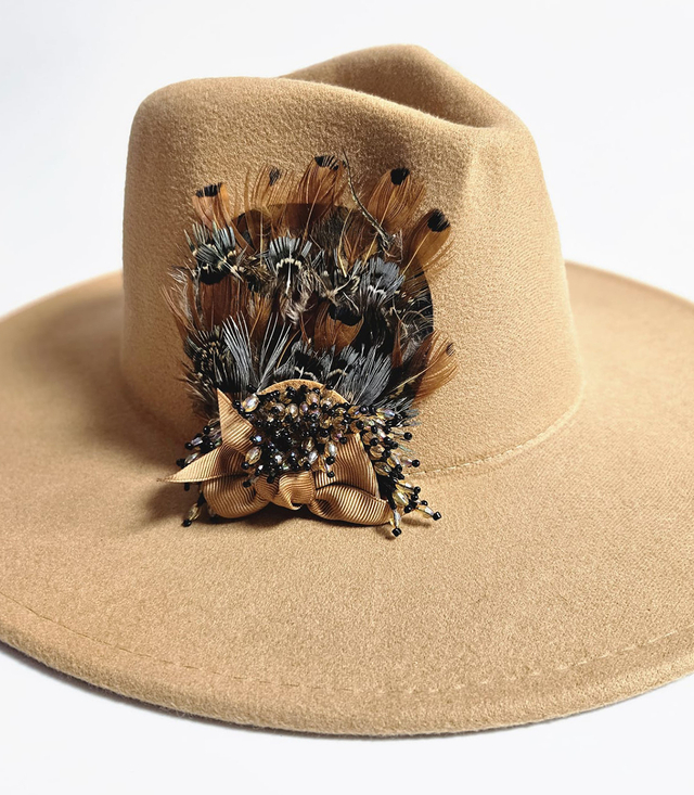 Elegant women's panama hat with decorative brooch with feathers and beads