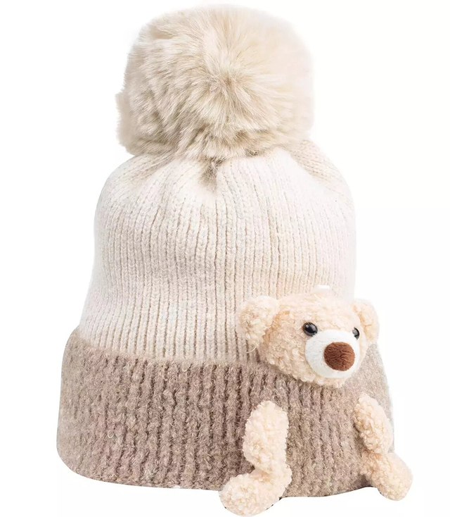 A warm fluffy hat with a pompom and fleece teddy bear