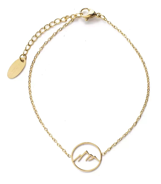 Gold bracelet with a round pendant with mountains