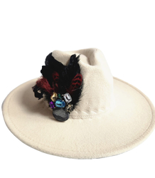 Elegant women's hat with large brooch with feathers and colored zircons