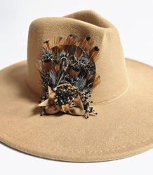 Elegant women's panama hat with decorative brooch with feathers and beads