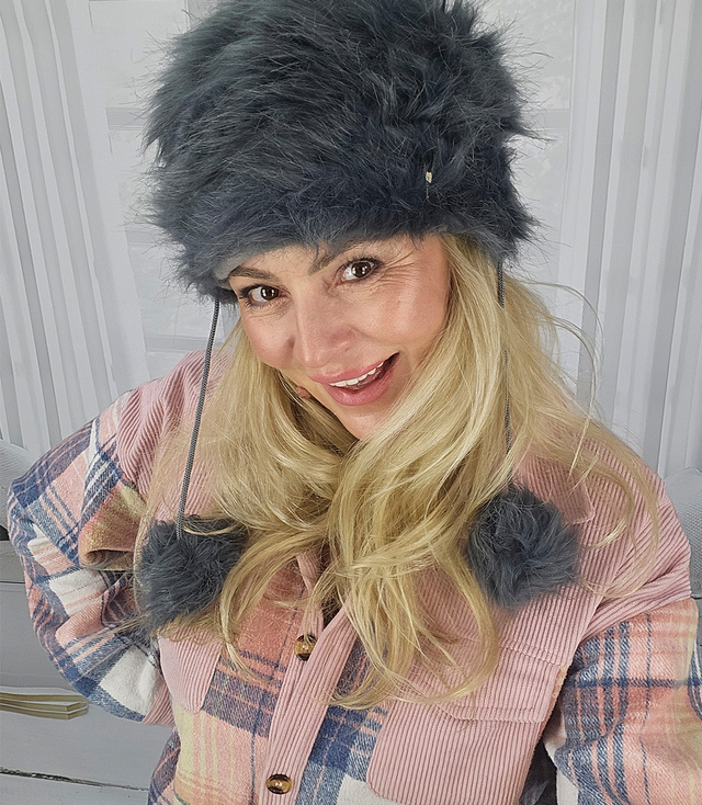 Fluffy winter beanie with pom-poms on strings