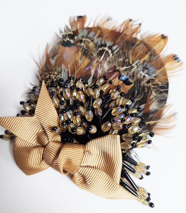 Elegant women's panama hat with decorative brooch with feathers and beads