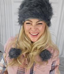 Fluffy winter beanie with pom-poms on strings