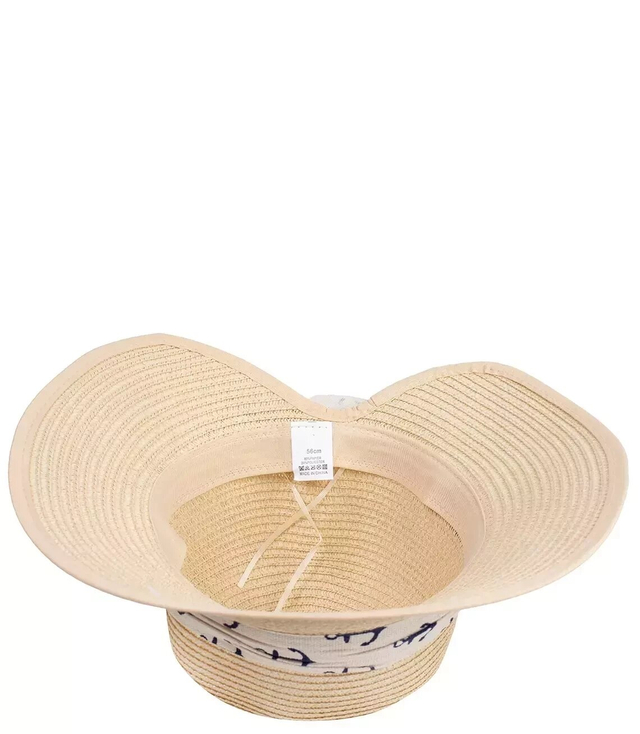 Stylish straw hat with a bow in anchors