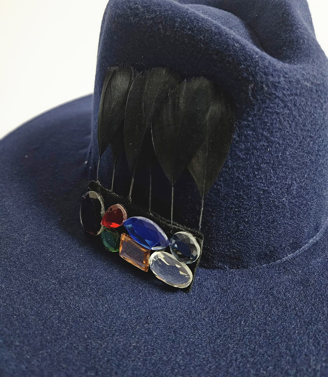 Elegant women's fedora hat with decorative brooch with colored zircons