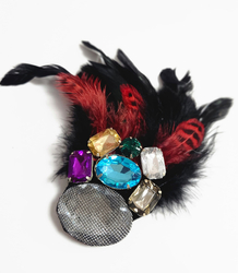 Elegant women's hat with large brooch with feathers and colored zircons