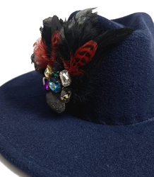 Elegant women's hat with large brooch with feathers and colored zircons