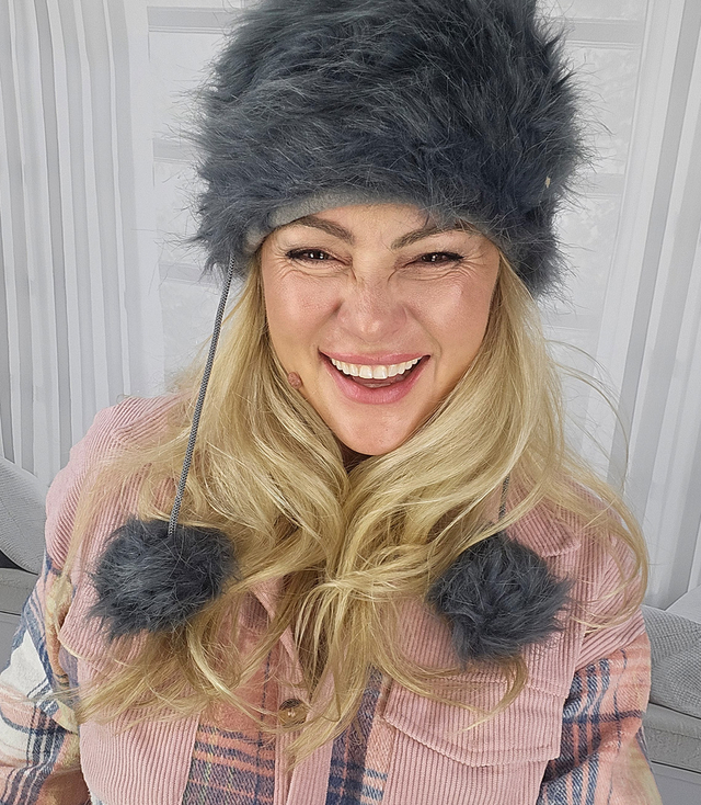 Fluffy winter beanie with pom-poms on strings