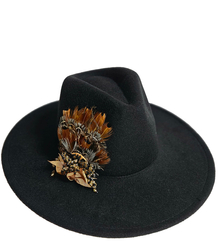 Elegant women's panama hat with decorative brooch with feathers and beads