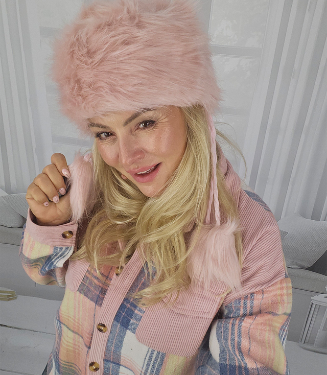 Fluffy winter beanie with pom-poms on strings