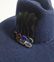 Elegant women's fedora hat with decorative brooch with colored zircons