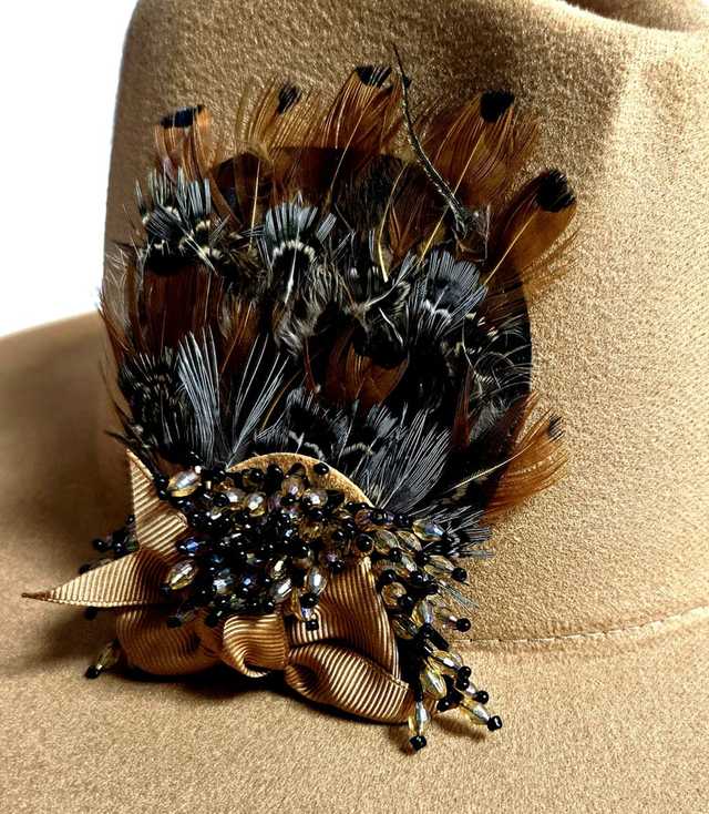 Elegant women's panama hat with decorative brooch with feathers and beads