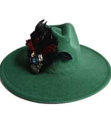 Elegant women's hat with large brooch with feathers and colored zircons